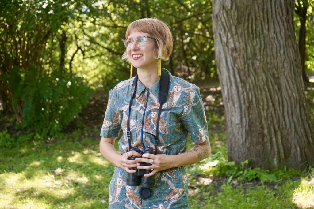 Dr. Rachel Buxton looks to the left at birds on Carleton University's campus.