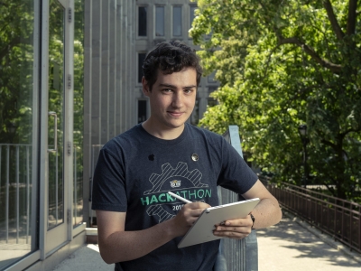 Avery Vine poses for the camera while writing on an iPad