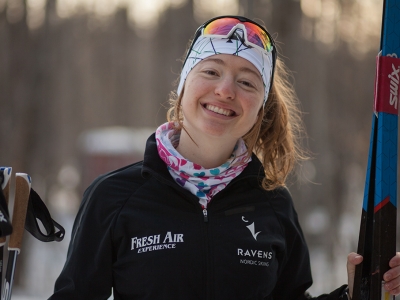 Zoë Williams smiles at the camera with her skis