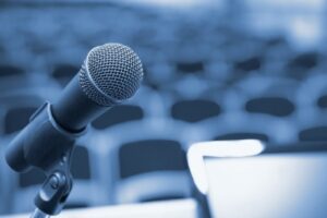 Rostrum with microphone and computer in conference hall