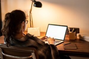 A student works remotely from home on a laptop
