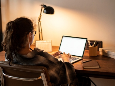 A student works remotely from home on a laptop